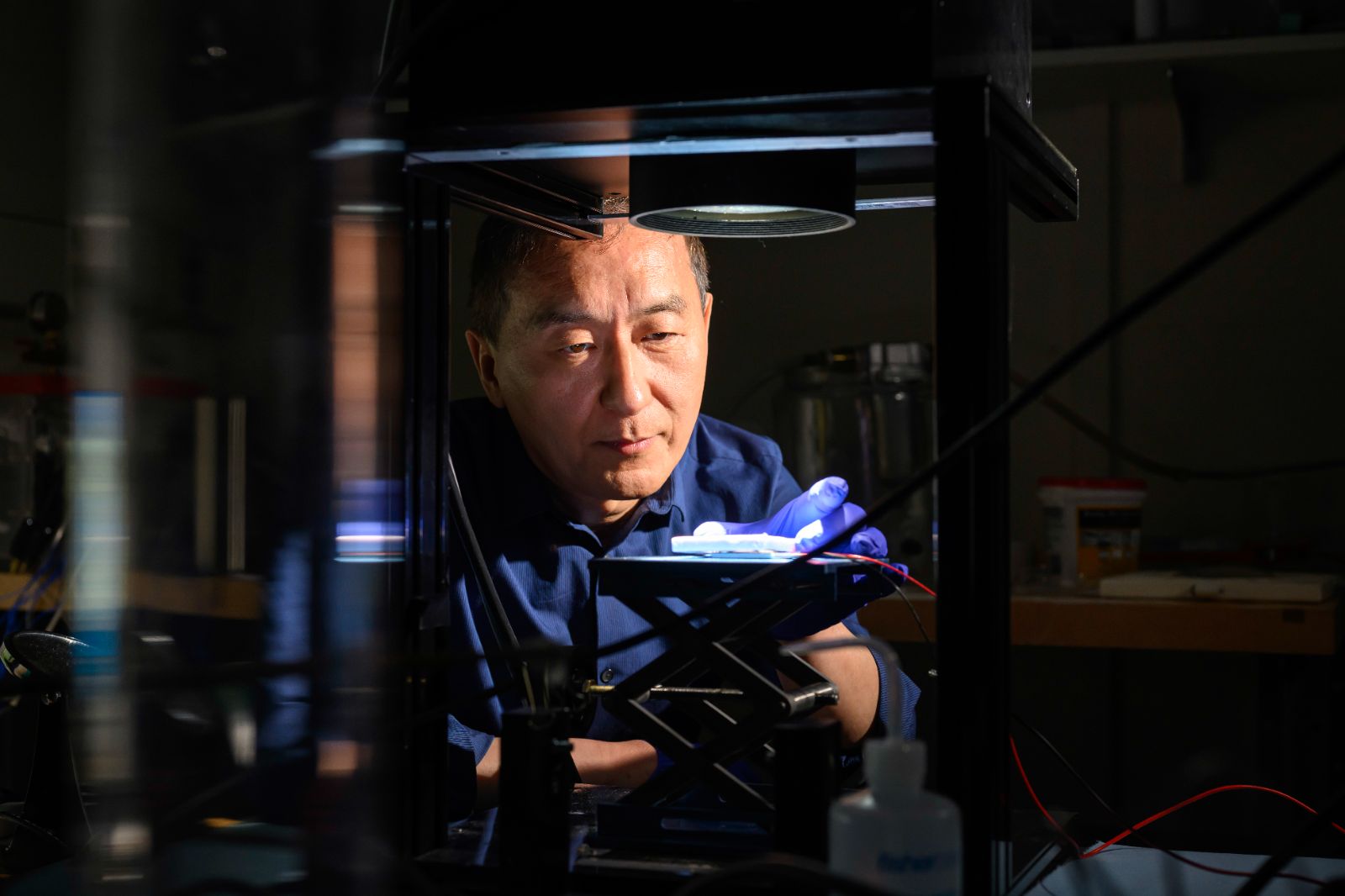 A man in a University of Rochester lab examines data on a computer screen.